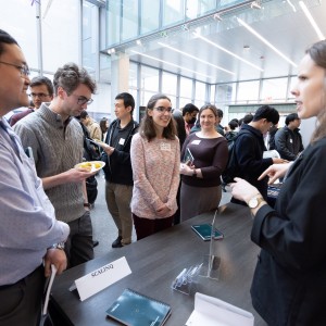 Photo of students, researchers, and industry professional in the midst of conversation over a table at the 2023 Chicago Quantum Recruiting Forum